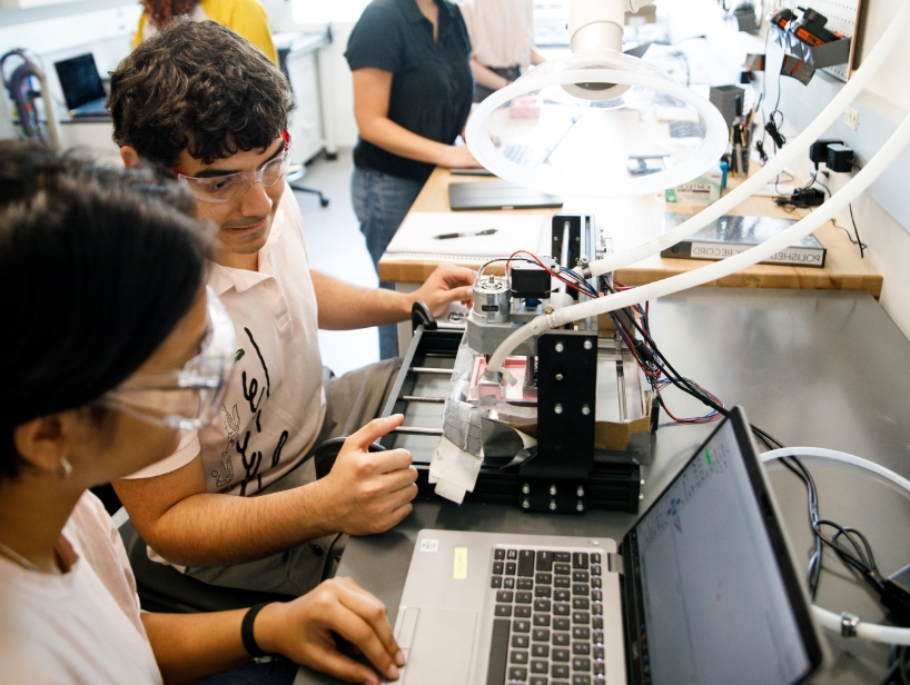 Two people working on computers in a laboratory.