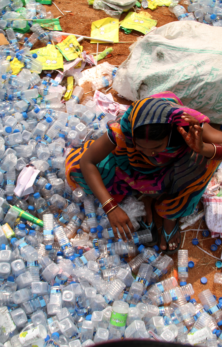Person standing waist deep in plastics.