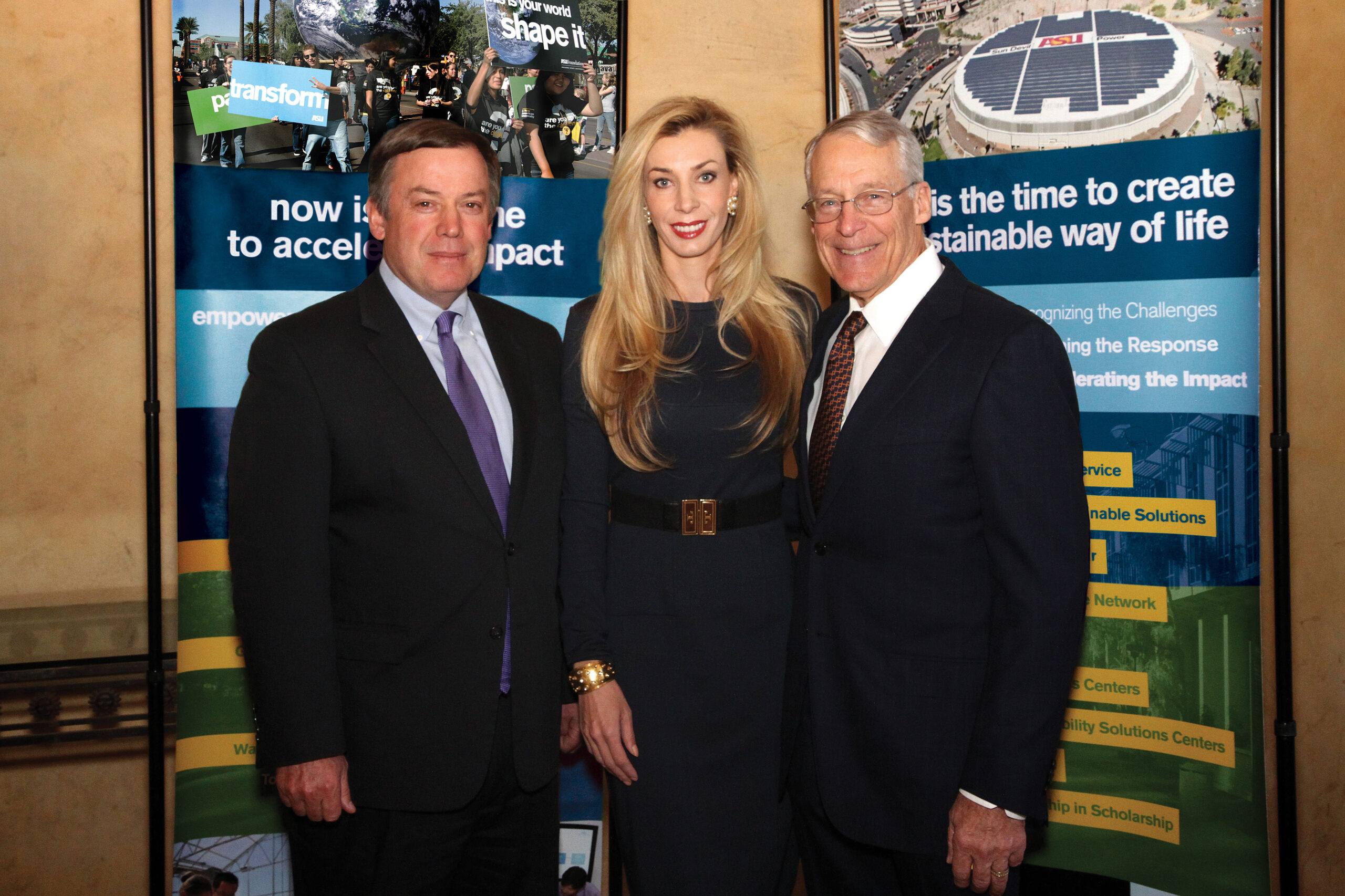 Michael Crow standing with Melani Walton and Rob Walton