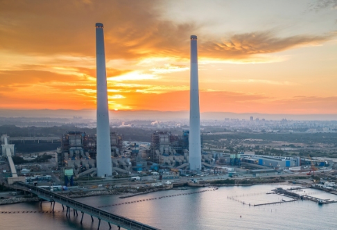 Aerial view of an urban cityscape on the waterfront at sunset.