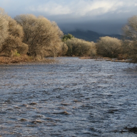 Stormy weather over flowing river