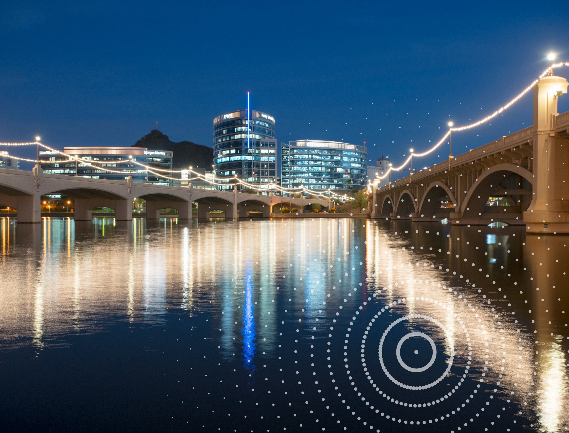 Tempe Town Lake, Arizona, at night overlaid with decorative swirls.